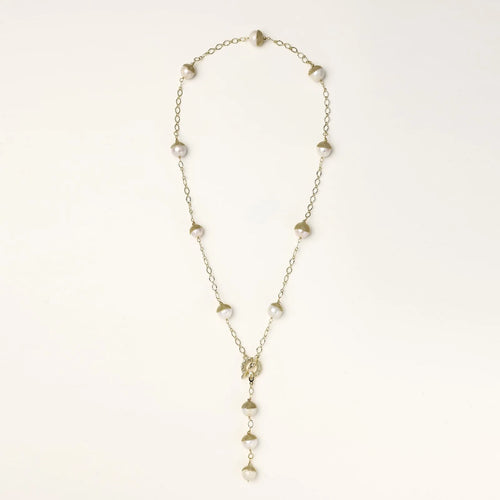 Gold-plated lariat necklace with baroque pearls and textured caps on cream background, showing adjustable Y-shaped design.