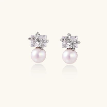 White gold stud earrings with square crystal stones in twisted frames and pink freshwater pearl drops below