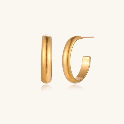 Chunky brushed gold hoop earrings in 14K plated stainless steel on cream background, front and side view.