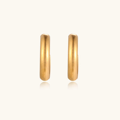 Chunky brushed gold hoop earrings in 14K plated stainless steel on cream background, front and side view.